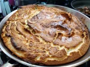 The image shows an almost dutch baby. Instead of it being fluffy and tall, like a popover, mine came out flat.