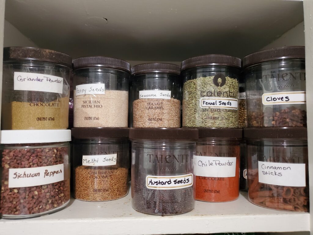 Rows and rows of Talenti ice cream containers filled with spices. 